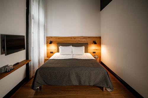 a bedroom with a bed and a television in it at Hotel Rum Budapest in Budapest