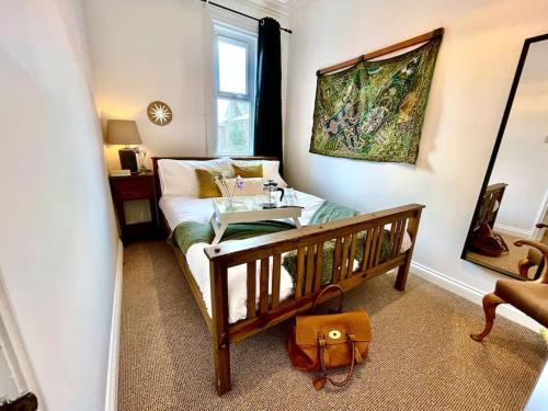 a small room with a bed and a table in it at Nomi Homes*Exeter*City*Centre*Uni*Chiefs*Beaches in Exeter