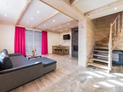 sala de estar con sofá y escalera en Domki u Jasia, en Zakopane