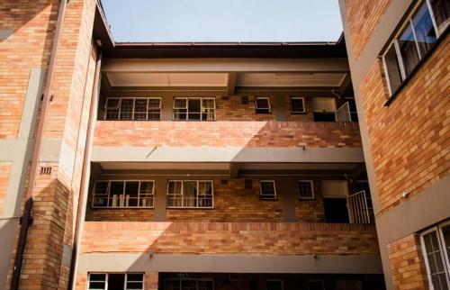a brick building with windows on the side of it at Pulse Building in Johannesburg