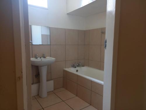 a bathroom with a sink and a bath tub at Pulse Building in Johannesburg