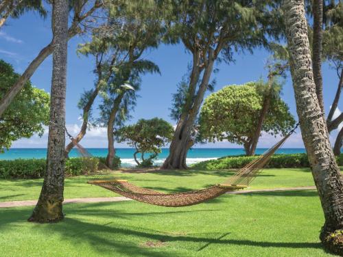 a beach with palm trees and palm trees at Kauai Coast Resort at the Beach Boy in Kapaa