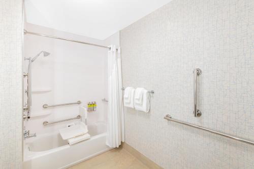a bathroom with a shower and a sink at Holiday Inn Express & Suites - Phoenix - Airport North by IHG in Phoenix
