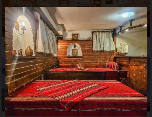 a room with two beds in a brick wall at Къща за гости Карасански in Bansko