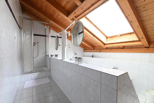 a bathroom with a shower and a sink at Gästehaus Huber in Immenstaad am Bodensee