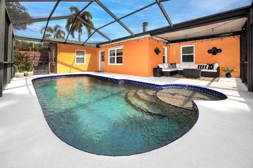 a swimming pool in the backyard of a house at Clearwater Cabana - Gorgeous Home with Heated Pool in Clearwater