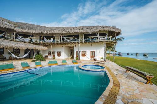 a resort with a swimming pool in front of a building at 7 Beaufort - Kitesurf Pousada in Itarema