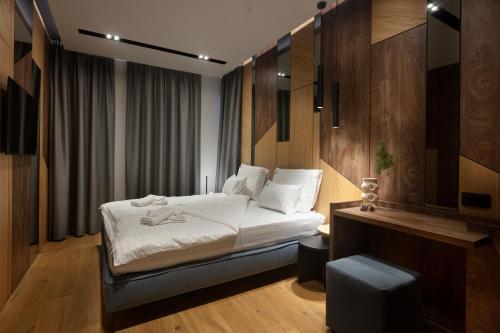 a hotel room with a bed and a chair at Galeria Jahorina Luxury Ski Apartments and Restaurant in Jahorina