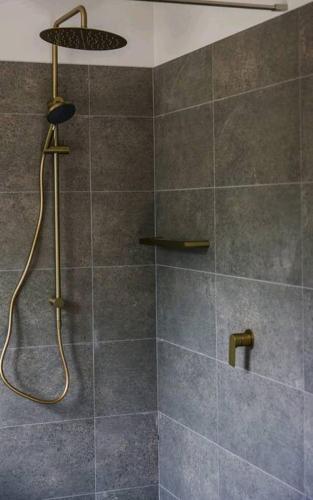 a bathroom with a shower with a shower head at Periwinkle at Great Bay in Great Bay