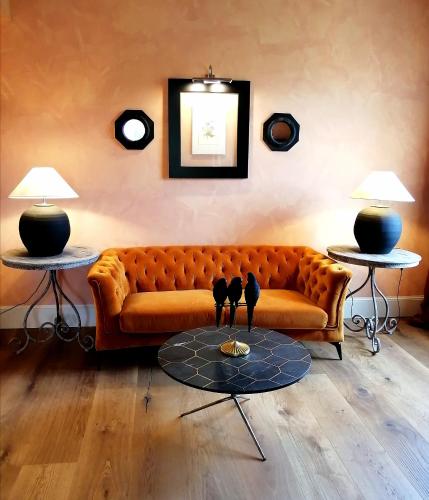 a living room with a couch and two tables at L'Andana Tenuta La Badiola in Castiglione della Pescaia