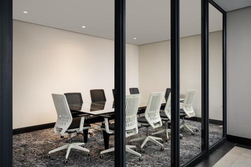 a conference room with a table and chairs at Premier Splendid Inn Umhlanga in Durban