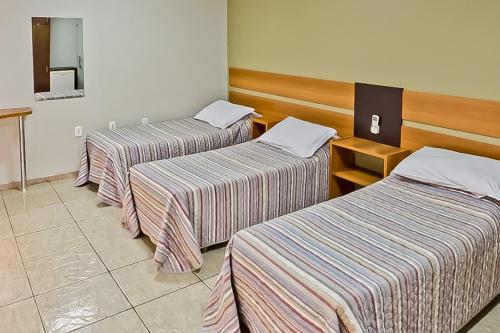 Ένα ή περισσότερα κρεβάτια σε δωμάτιο στο Tri Hotel Centro Chapecó