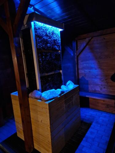 a room with a tank with blue lights at Apartamenty przy Jeziorze Żywieckim z widokiem na Skrzyczne in Żywiec