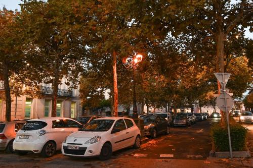 a bunch of cars parked on the side of a street at L'orchidée #Hyper-centre #Marché couvert in Cognac