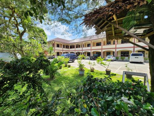 a building with a lot of plants in front of it at MB Apartments & Hotel Medan in Sunggal