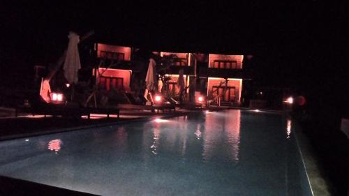 a swimming pool at night with lights in it at Gubug Balian Beach Bungalow in Selemadeg