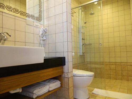a bathroom with a sink and a toilet and a shower at The Domed Tile B&B in Magong