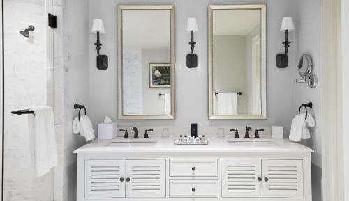 a bathroom with a white sink and two mirrors at Pursell Farms in Fayetteville