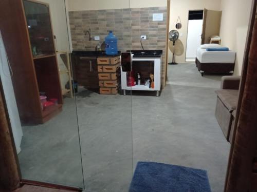 a living room with a glass partition in a room at Residencial e Chalés Cristal in Palmeiras