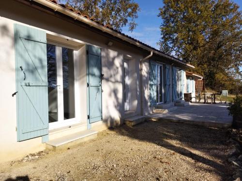 a house with blue doors and a patio at La Coste Blanque in Montaut