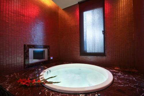 a large bath tub in a bathroom with a tv at Lanshy Motel in Taichung