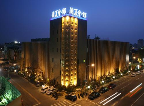 a building with a sign on top of it at night at Lanshy Motel in Taichung