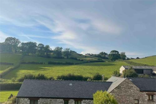 a view of a green field from a house at Clare's Cottage Near Cartmel - Dog Friendly, Homely, Aga, Log Burners, Disney Plus & Netflix in Holker