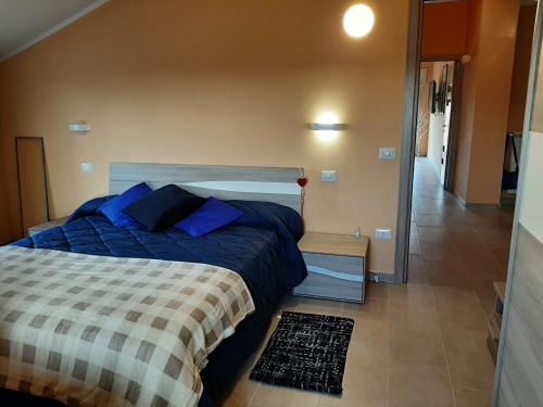 a bedroom with a bed with blue pillows on it at B&B A casa di Tetta in Telese