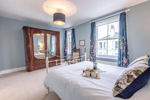 a bedroom with a white bed and a window at 21 Park Lane, Aldeburgh in Aldeburgh