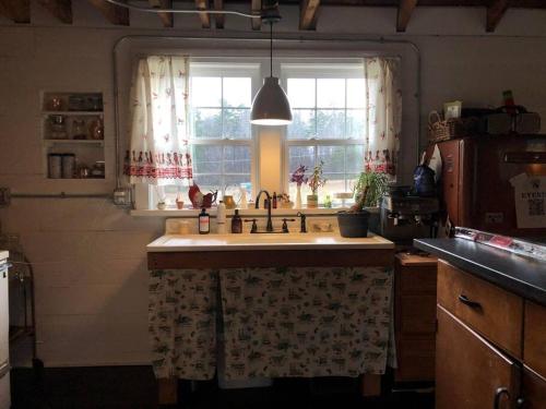 a kitchen with a sink and a window at The Schoolhouse vintage home on the farm 