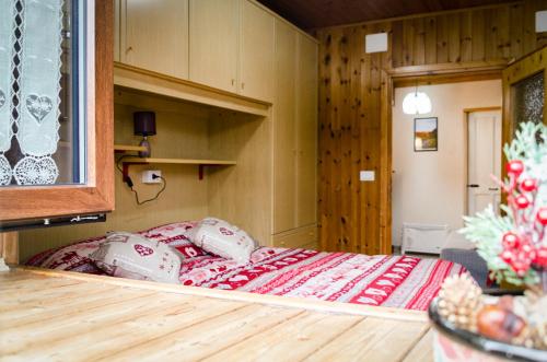 Cama grande en habitación con suelo de madera en Maison Rhémy - Relax e montagne, en Saint-Rhémy-en-Bosses