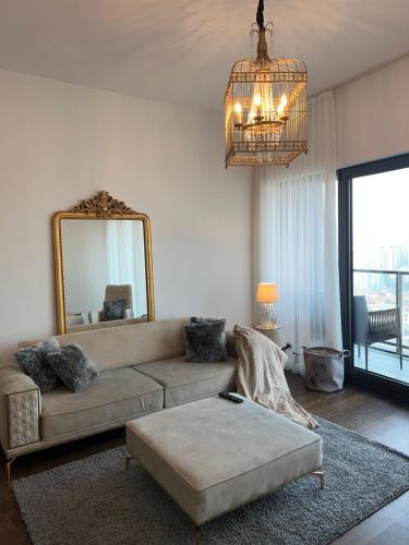 a living room with a couch and a mirror at Rotana apartment in Istanbul