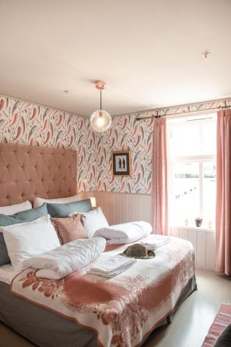 a bedroom with a large bed with a blanket on it at Knutholmen in Kalvåg