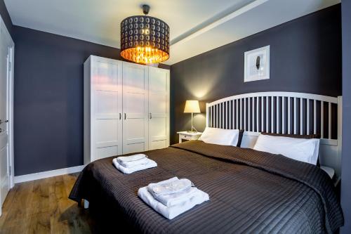 a bedroom with a bed with two towels on it at Luxury Hotel Room 735 at Orbi Palace in Bakuriani in Bakuriani