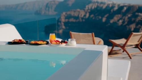 a table with food on it with a view of the grand canyon at Nelya Suites in Megalochori