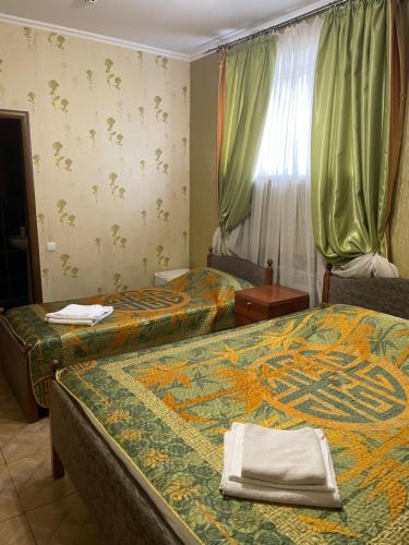 頓河畔羅斯托夫的住宿－Guest House Natalia，酒店客房设有两张床和窗户。