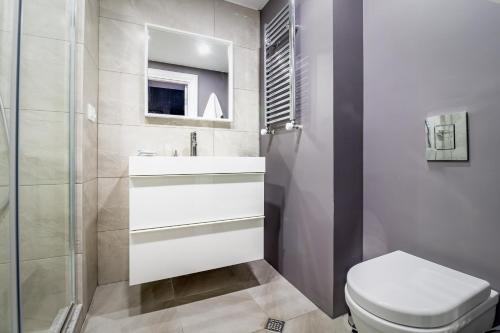 a bathroom with a toilet and a sink and a mirror at Luxury Hotel Room 735 at Orbi Palace in Bakuriani in Bakuriani