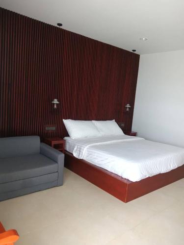 a bedroom with a bed and a couch in it at Beach house by Rose massage in Nai Thon Beach