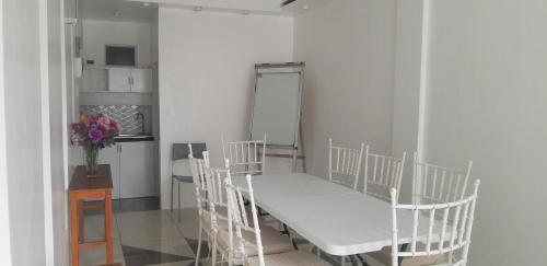 a hospital bed in a room with a vase of flowers at Innsite Room Rentals in Manila