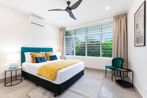 a bedroom with a large bed and a window at 'Botanica Paradiso' A Vibrant Nightcliff Solace in Nightcliff