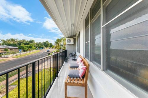 a balcony with two benches on a house at 'Botanica Paradiso' A Vibrant Nightcliff Solace in Darwin