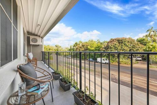 a balcony with chairs and a view of a street at 'Botanica Hoja' A Nightcliff Balcony Refresh in Nightcliff