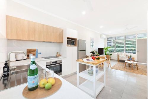 a kitchen with a bottle of wine on a table at 'Botanica Hoja' A Nightcliff Balcony Refresh in Darwin