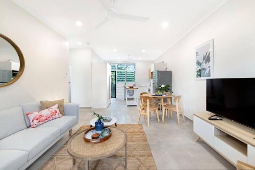 a living room with a couch and a tv at 'Botanica Hoja' A Nightcliff Balcony Refresh in Darwin