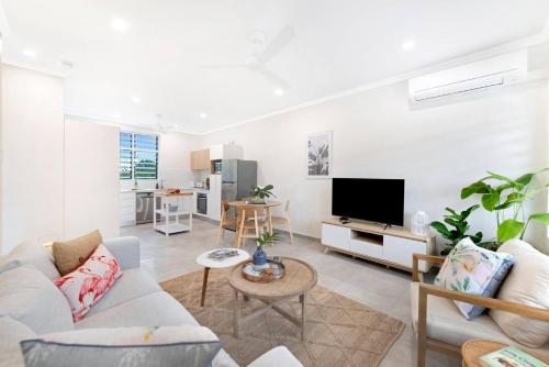 a living room with a couch and a tv at 'Botanica Hoja' A Nightcliff Balcony Refresh in Nightcliff