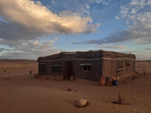 a small building in the middle of the desert at Sahara Peace camp in Zagora