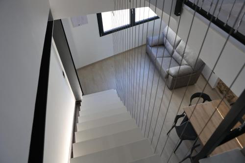 an overhead view of a staircase with a chair and a couch at Ca ma mare in Useras