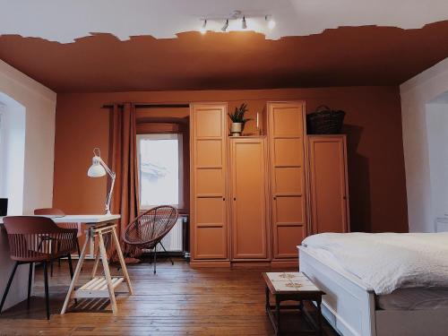 una stanza con un letto, una scrivania e un tavolo di Cottage43 a Bărcuţ