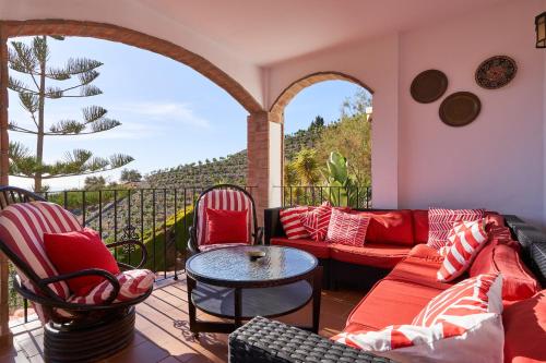 a living room with a couch and chairs on a balcony at Group Villa 14 Pool wifi Air in Frigiliana