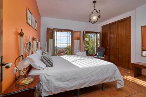 a bedroom with a large white bed and a desk at Group Villa 14 Pool wifi Air in Frigiliana